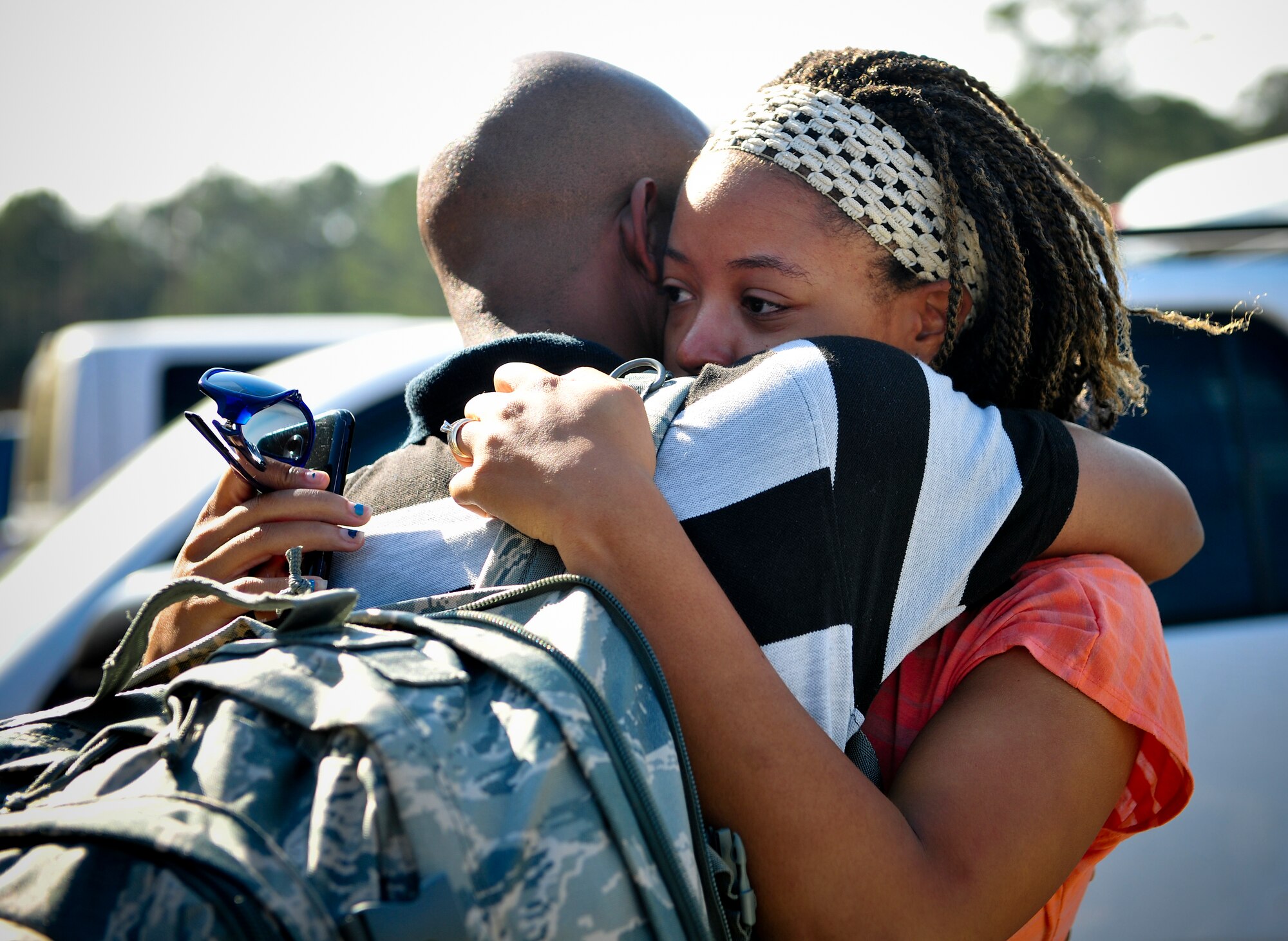 U.S. Air Force Senior Airman Francis De La Cruz hugs his wife before boarding a bus Jan. 29, 2013, on Moody Air Force Base, Ga. De La Cruz is part of the 23d Logistics Readiness Squadron and will be deployed for at least six months to Europe. (U.S. Air Force photo by Airman Alexis Grotz/Released)