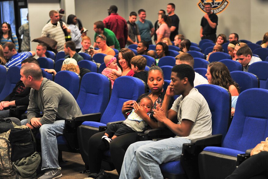 U.S. Air Force Airmen and families wait for a bus before deploying Jan. 29, 2013, at Moody Air Force Base, Ga. Various Airmen are from the 23d Maintenance Group, 347th Rescue Squadron and 23d Logistics Readiness Squadron  and deployed to Europe for a six month tour. (U.S. Air Force photo by Airman Alexis Grotz/Released)