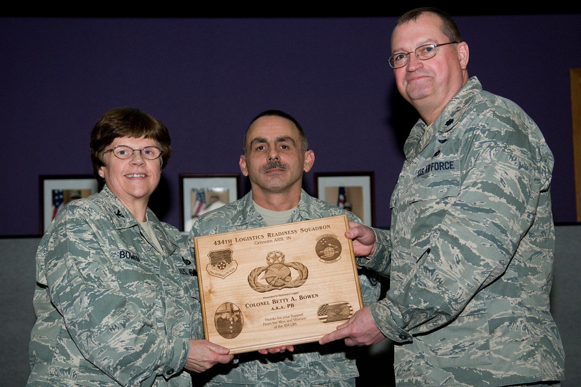 GRISSOM AIR RESERVE BASE, Ind. -- Lt. Col. Bryan Runion, right, and Senior Master Sgt. Tim O'Brien present Col. Betty Bowen, 434th Mission Support Group commander with a plaque during her last commander's call here Jan. 6. Bowen officially retired Jan. 31 after a 32-year military career. Runion is the 434th Logistics Readiness Squadron commander and O'Brien is the 434th LRS logistics plans superintendent. (U.S. Air Force photo/Tech. Sgt. Mark R. W. Orders-Woempner)
