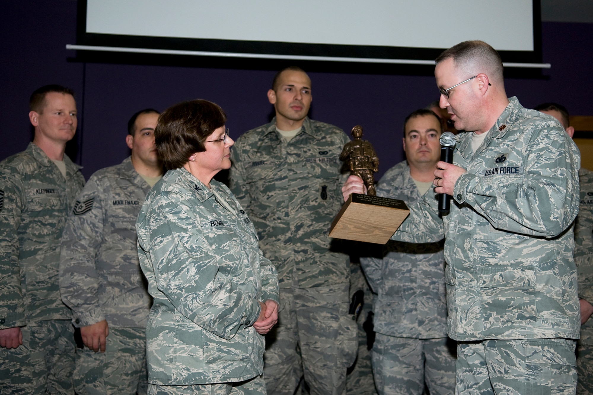 GRISSOM AIR RESERVE BASE, Ind. -- Surrounded by 434th Security Forces Squadron Airmen, Maj. Christopher Witter, 434th SFS commander, presents Col. Betty Bowen, 434th Mission Support Group commander, with a security forces statue during her last commander's call Jan. 6. Bowen officially retired Jan. 31 after a 32-year military career. (U.S. Air Force photo/Tech. Sgt. Mark R. W. Orders-Woempner)
