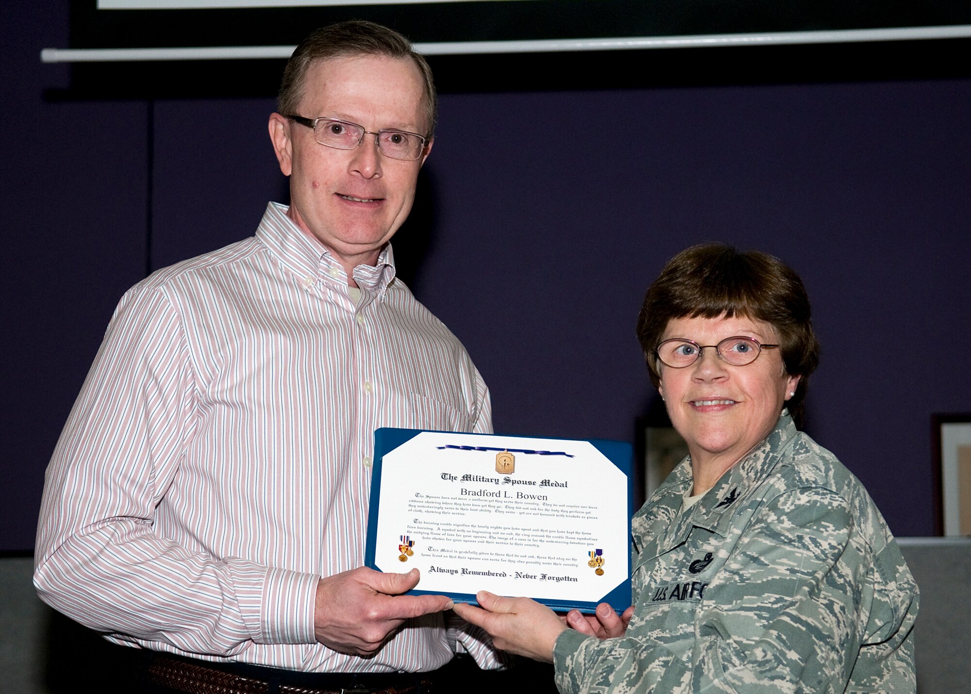GRISSOM AIR RESERVE BASE, Ind. -- Col. Betty Bowen, 434th Mission Support Group commander, presents her husband, Bradford, with a Military Spouse Medal in appreciation for his support of her 32-year military career Jan. 6. Bowen officially retired on Jan. 31. (U.S. Air Force photo/Tech. Sgt. Mark R. W. Orders-Woempner)
