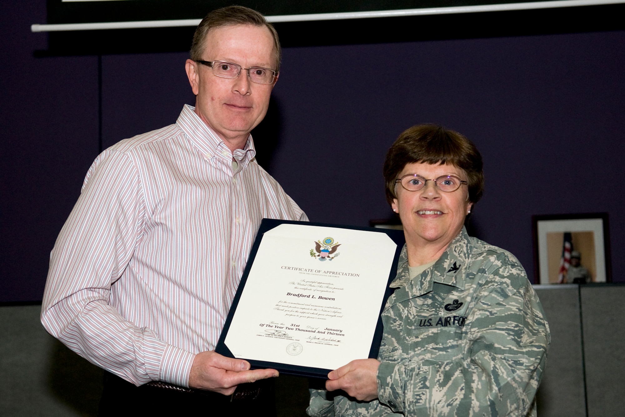 GRISSOM AIR RESERVE BASE, Ind. -- Col. Betty Bowen, 434th Mission Support Group commander, presents her husband, Bradford, with a certificate of appreciation for his support of her 32-year military career Jan. 6. Bowen officially retired on Jan. 31. (U.S. Air Force photo/Tech. Sgt. Mark R. W. Orders-Woempner)
