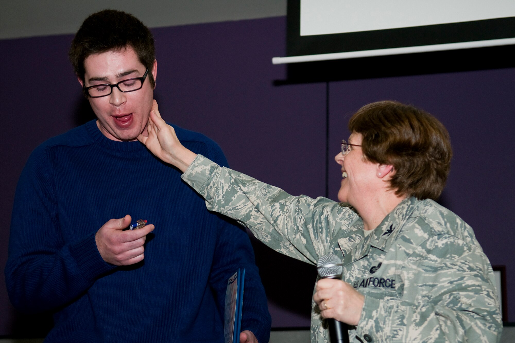 GRISSOM AIR RESERVE BASE, Ind. -- Col. Betty Bowen, 434th Mission Support Group commander, shares a tender moment with her son, Mark, shortly after presenting him with a medal and certificate in appreciation of his support of her military career Jan. 6. Bowen officially retired from the Air Force Reserve on Jan. 31 after over 32 years of service. (U.S. Air Force photo/Tech. Sgt. Mark R. W. Orders-Woempner)

