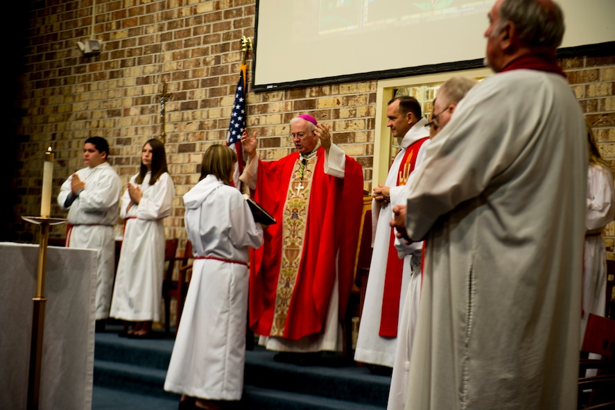 Bishop Richard Higgins, vicar for Veterans Affairs, reads Catholic scriptures during Confirmation Mass Jan. 29, 2013, at the Moody Air Force Base, Ga., chapel. Higgins visited Moody to administer the confirmation of five individuals. (U.S. Air Force photo by Staff Sgt. Jamal D. Sutter/Released)  