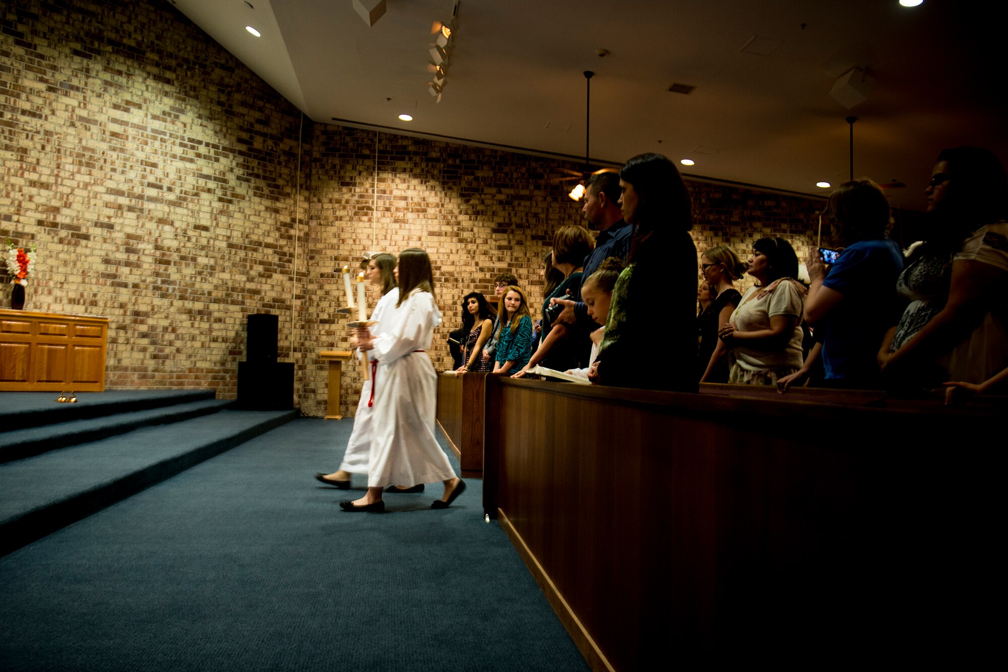 Megan Frazier and Sierra Grucella perform altar-server duties during Confirmation Mass Jan. 29, 2013, at the Moody Air Force Base, Ga., chapel. Confirmation is an important part of a Catholic’s religious journey. (U.S. Air Force photo by Staff Sgt. Jamal D. Sutter/Released)