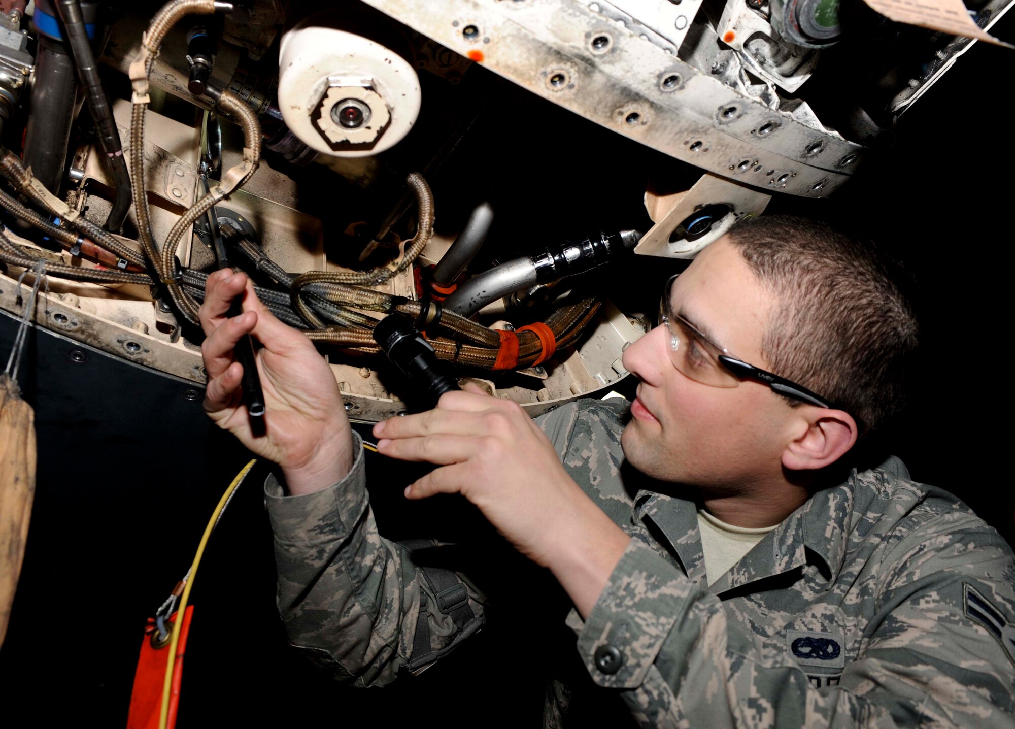 Airman 1st Class Jesse Burton, 28th Maintenance Squadron aerospace maintenance technician, inspects the hydraulic lines underneath a B-1 during an isochronal inspection at Ellsworth Air Force Base, S.D., Jan. 15, 2013. Hydraulic lines are routinely inspected to prevent failure which could result in a crash. (U.S. Air Force photo by Airman 1st Class Anania Tekurio/Released)