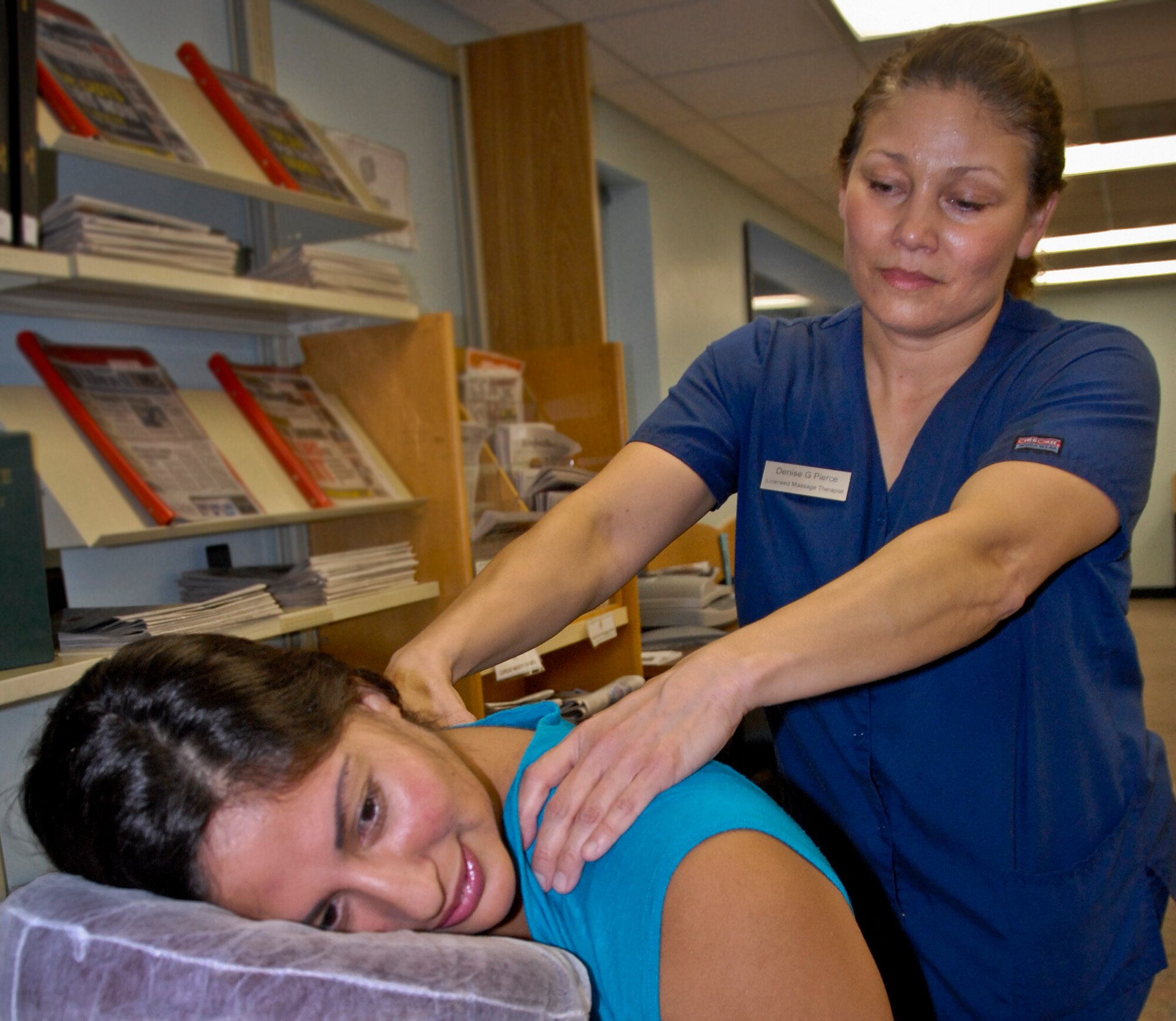 Denise Pierce, a licensed massage therapist at Eglin Air Force Base’s fitness center and annex, gives Anita Marte a massage at the “Lasting Resolutions” event at the base library Jan. 30.  Representatives from the fitness center and annex, health and wellness center, civilian health promotions service and outdoor recreation teamed up with the library to motivate patrons to stay on track with their New Year’s fitness resolutions.  Approximately 80 people attended the event.   (U.S. Air Force photo/Kevin Gaddie)
