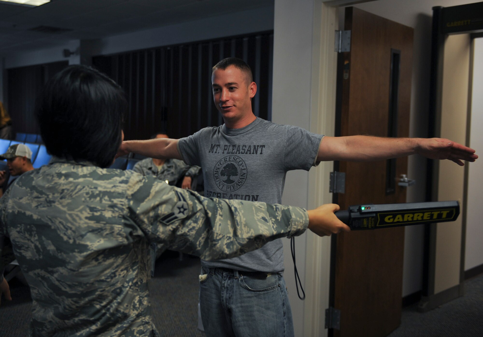 U.S. Air Force Airman 1st Class Jesly Galang, 23d Logisitics Readiness Squadron air terminal operations, checks for metal on Staff Sgt. Lee Runey, 71st Aircraft Maintenance Unit crew chief, at Moody Air Force Base, Ga., Jan. 29, 2013. Members of the 23d Maintenance Group, 347th Rescue Group and 23d Logistics Readiness Squadron deployed to Italy to support overseas operations.  (U.S. Air Force photo by Airman 1st Class Olivia Bumpers/Released)