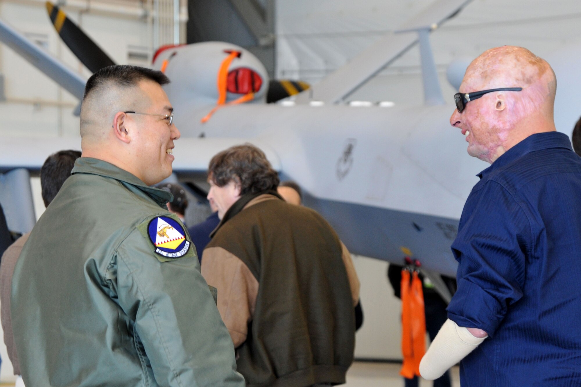 CREECH AIR FORCE BASE, Nev. – A Creech Airman talks with a wounded warrior about the MQ-9 Reaper during his visit to Creech AFB, Jan. 28. The wounded warriors came to Creech as part of a tour of the Las Vegas area. (U.S. Air Force photo by Staff Sgt. Nadine/RELEASED)

