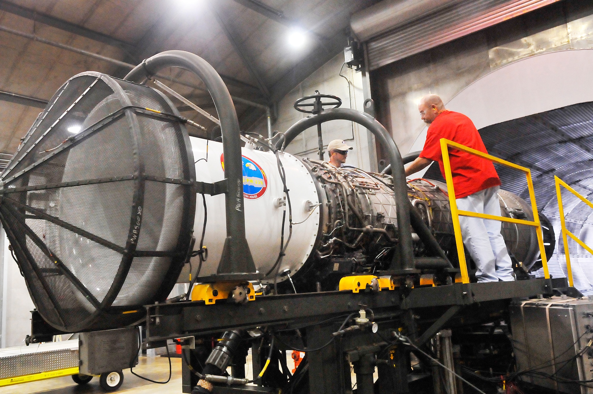 Hugh Rooks and Brian Greenwood, jet engine mechanics, prepare an F-15 engine for a  run test. The F-15 Engine Shop received its VPP Gold Banner in January.(U. S. Air Force photo/Sue Sapp)