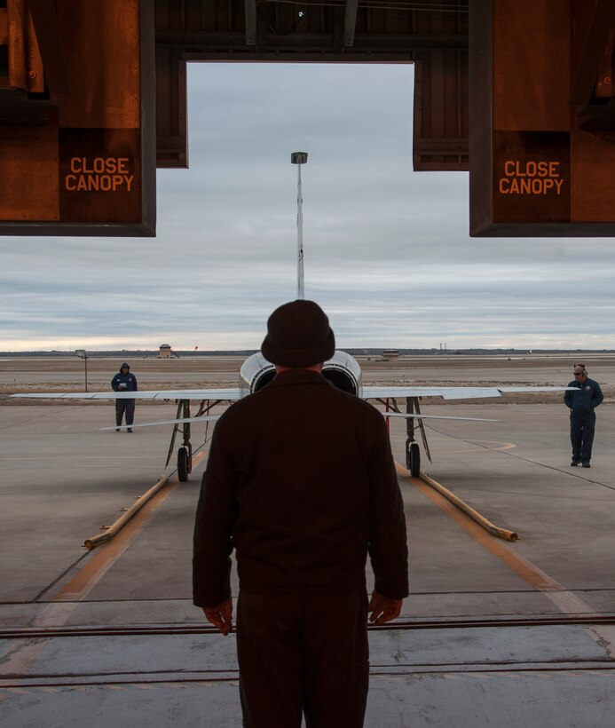 Lenny Prevatt, 47th Maintenance Directorate engine mechanic, guides a T-38 Talon back into the Hush House for an engine wash at Laughlin Air Force Base, Texas, Jan. 22, 2013. The 11 T-38 engine mechanics keep 66 T-38 Talons operational to support Laughlin’s mission of producing the world’s best pilots. (U.S. Air Force photo/2nd Lt. David Tart)