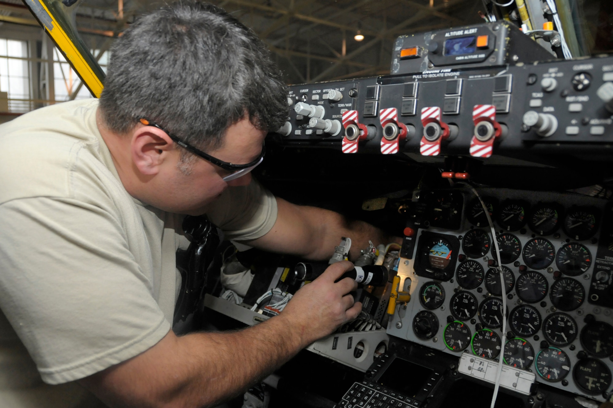 Technical Sgt. John Kerschenheiter, an avionics technician with the 191 Maintenance Squadron connects wiring for a new antennae to the flight controls of a KC-135 Stratotanker at Selfridge Air National Guard Base, Mich., Jan. 30, 2013. The KC-135, assigned to the 127th Air Refueling Group of the Michigan Air National Guard, was being outfitted with the additional antennae to allow it to serve as a platform for testing a prototype of a new aircraft defense system. (Air National Guard photo by Brittani Baisden)