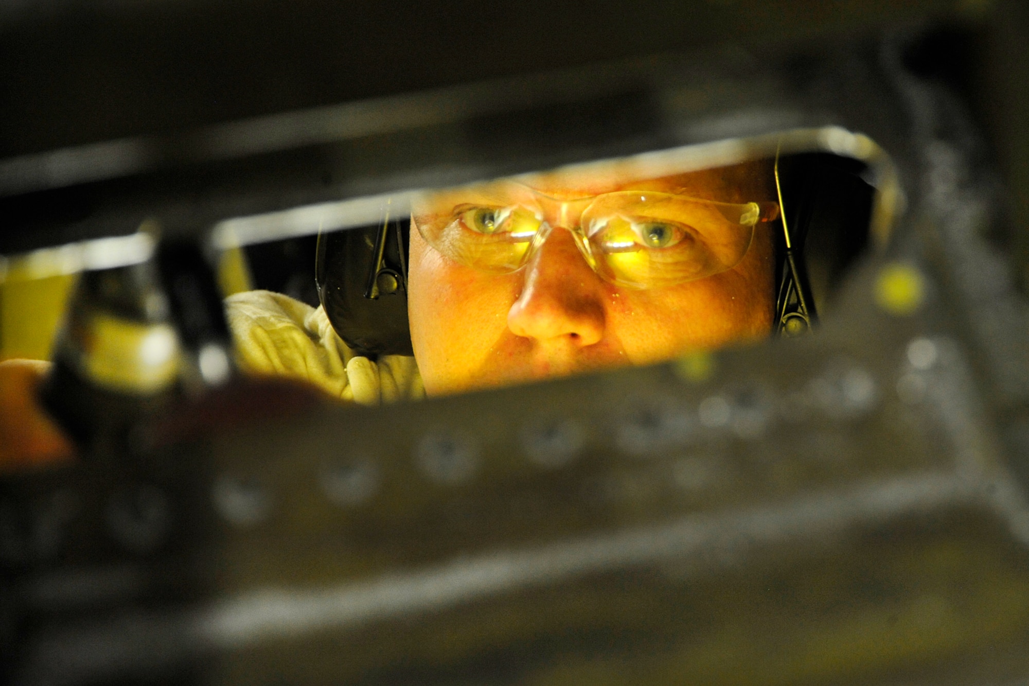 Technical Sgt. Bart Davidson, 191st Maintenance Squadron, cuts an opening in the floor of a KC-135 Stratotanker at Selfridge Air National Guard Base, Mich., Jan. 16, 2013. The KC-135, assigned to the 127th Air Refueling Group of the Michigan Air National Guard, was being prepared to serve as a platform for testing a prototype of a new aircraft defense system. (Air National Guard photo by John S. Swanson)