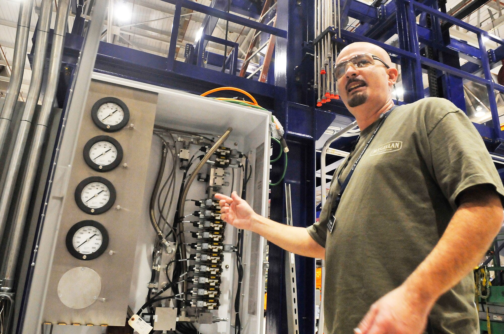 Ed Messer, production supervisor in the C-5 Landing Gear Shop, points out that the new work stand being installed in the shop wil have digital components. (U. S. Air Force photo/Sue Sapp)