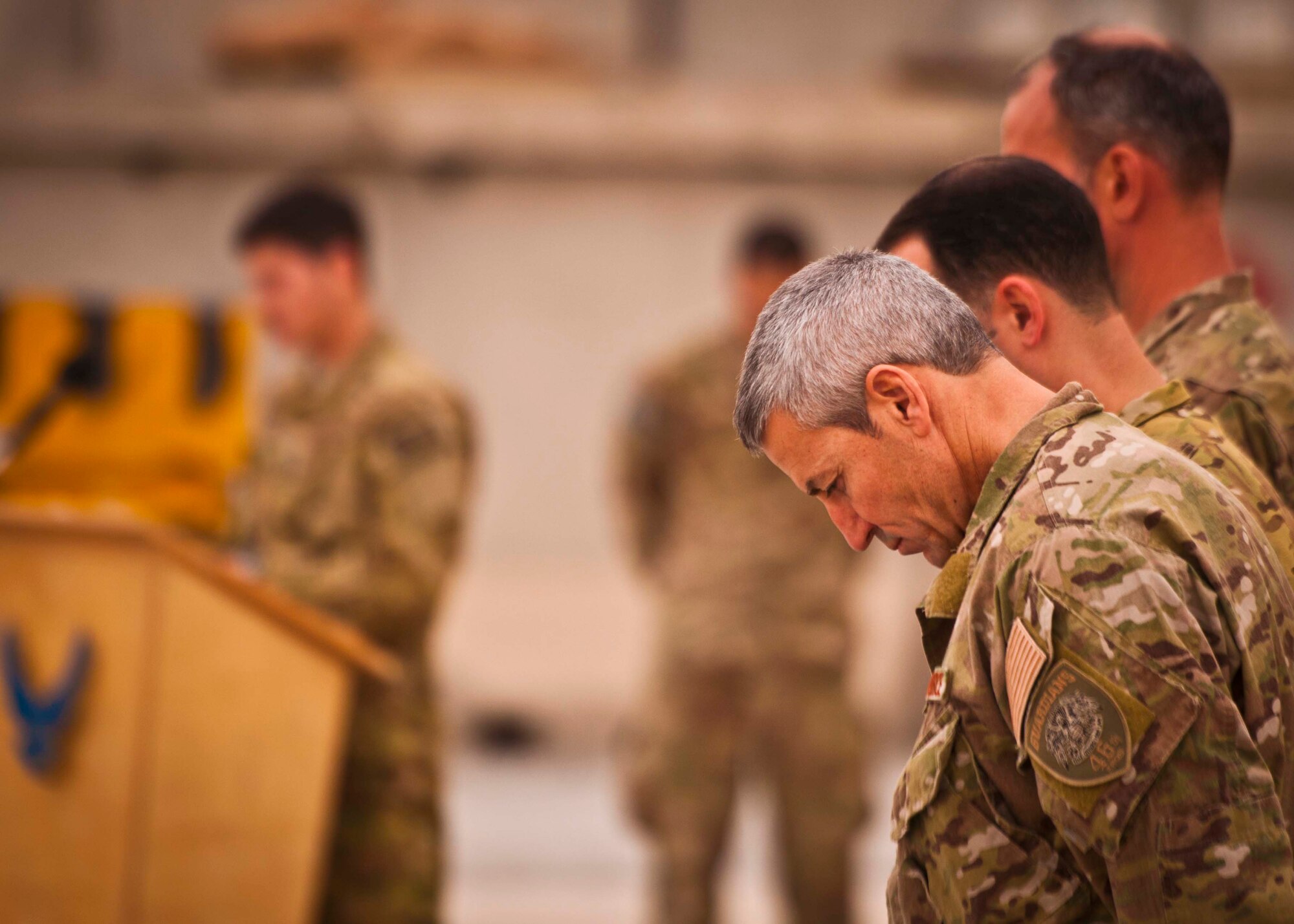 Maj. Joseph Barnard, 46th Expeditionary Rescue Squadron commander, bows his head at a ceremony Jan. 30 at Kandahar Airfield marking the inactivation of the 46th ERQS, including a detachment at KAF, and the redeployment of the 59th ERQS, which will not be replaced. The rescue mission at KAF draws to a close after 11 years, during which crews sat alert for 97,000 hours and saved nearly 1,200 lives. (U.S. Air Force photo/Senior Airman Scott Saldukas)