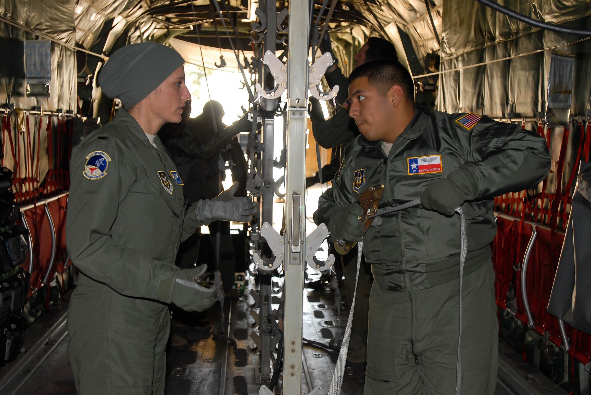 Airman 1st Class Nicholas Pacheco, a flight technician in the 433rd Aeromedical Evacuation Squadron, Corpus Christy, Texas and 1st Lt. Deanna Jensen, a flight nurse with the 934th Aeromedical Evacuation Squadron, Minneapolis, Minn., work together to configure the mock aircraft to accommodate litters of wounded service members for a simulated mass casualty exercise on Jan. 24, 2013, at the Aeromedical Evacuation Formal Training Unit at Pope Army Airfield, N.C.  (U.S. Army photo by Spc. Melissa C. Parrish)