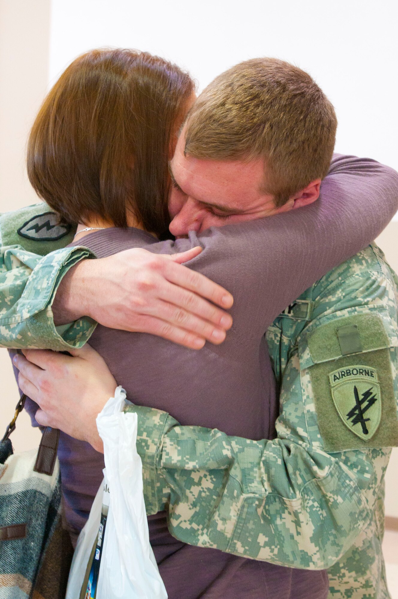 Sgt. Matthew Parson, 303rd Tactical Psychological Operation Company psyop sergeant, hugs his loved one during the Mobilization Ceremony Jan. 27, 2013, outside the McGarity U.S. Army Reserve Center, Pa. These Army Reserve soldiers will provide military information support operation with the Marines in various locations in Afghanistan. (U.S. Army photo by Sgt. 1st Class Andy Yoshimura/Released)