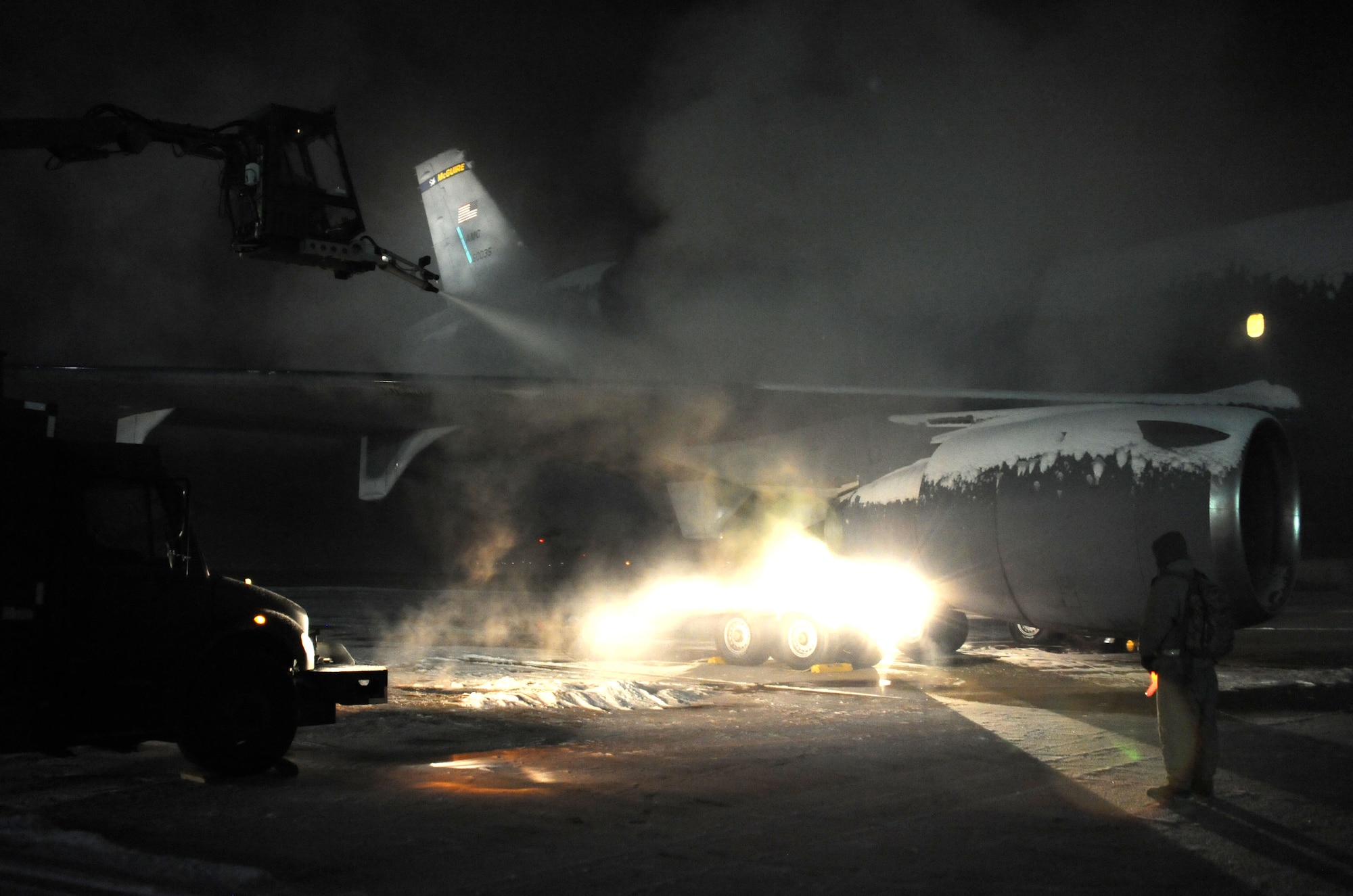 Members of the 605th Aircraft Maintenance Squadron work to deice a KC-10 Extender Jan. 25, 2013, on McGuire Airfield at Joint Base McGuire-Dix-Lakehurst, N.J. The snowstorm, the first of the year for JB MDL, brought two to four inches of snowfall to the area. (U.S. Air Force photo by 2nd Lt. David J. Murphy/Released)