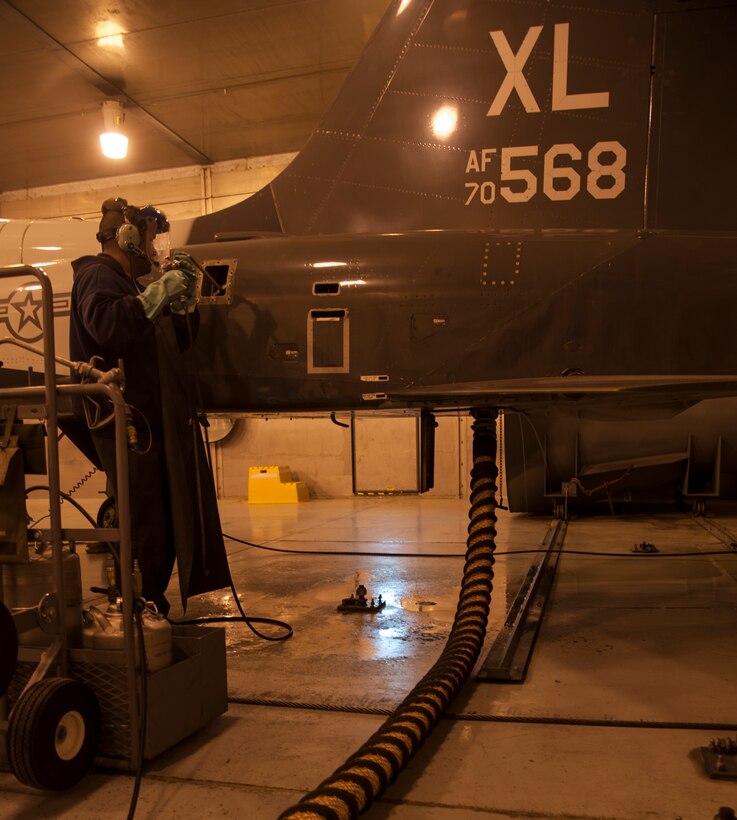 Patrick Martinez, 47th Maintenance Directorate engine mechanic, cleans a T-38 Talon’s engines during a routine clean in the Hush House at Laughlin Air Force Base, Texas, Jan. 22, 2013. The 11 T-38 engine mechanics keep 66 T-38 Talons operational to support Laughlin’s mission of producing the world’s best pilots. (U.S. Air Force photo/2nd Lt. David Tart)