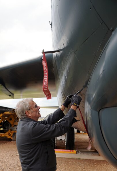 John Henry, Barksdale Global Power Museum volunteer, places a streamer on a B-52G Stratofortress on Barksdale Air Force Base, La., Jan. 30. The Barksdale Global Power Museum has an airpark which displays static aircraft and indoor exhibits. The airpark has various restored aircraft from World War II to the present. (U.S. Air Force photo/Airman 1st Class Benjamin Gonsier)