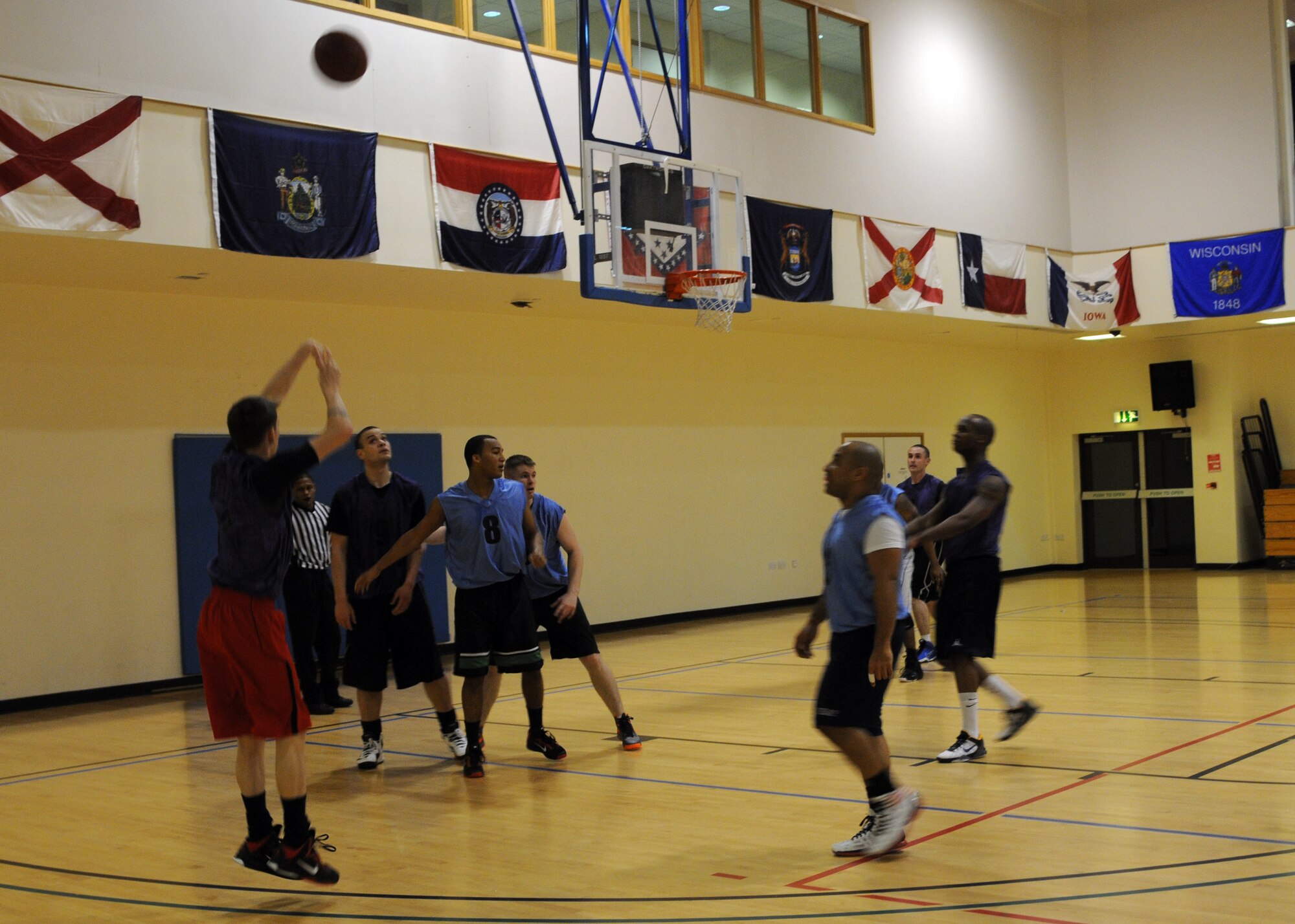 Left, Airman 1st Class James Brooks, 100th Logistics Readiness Squadron fuels apprentice, from Fayetteville Ark., shoots from the three-point line during an intramural basketball game Jan. 30, 2013, at the Hardstand Fitness Center at RAF Mildenhall, England.  The 100th LRS played against the 325nd Special Operations Support Squadron and beat them 62-60 in overtime. (U.S. Air Force photo by Airman 1st Class Kelsey Waters/Released)