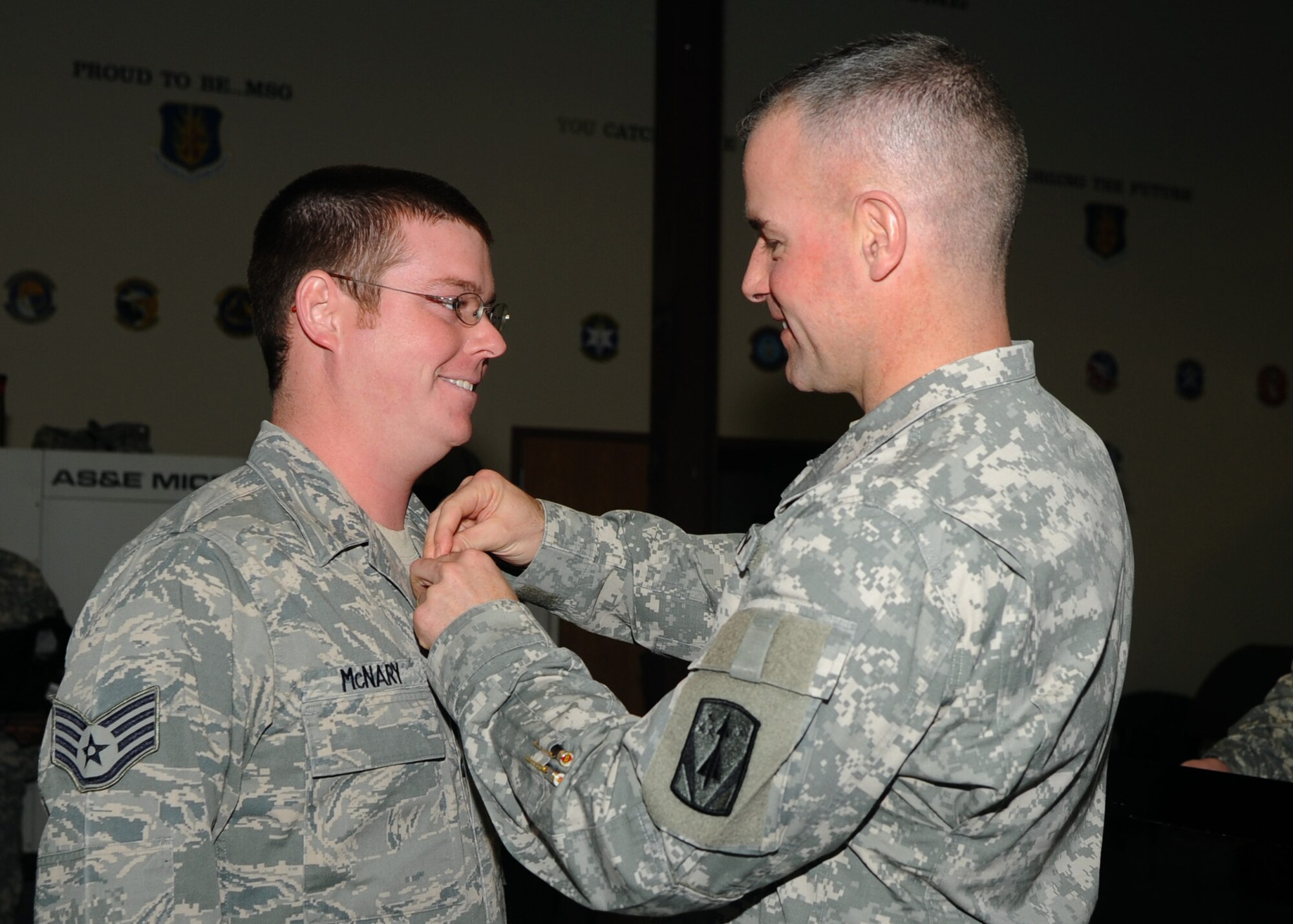 Army Col. Michael Morrissey, commander of the 31st Air Defense Artillery Battalion, Fort Sill, Okla., presents Staff Sgt. Timothy McNary of the Kentucky Air National Guard’s 123rd Contingency Response Group with the Army Achievement Medal during a ceremony at Altus Air Force Base, Okla., Jan. 9, 2013. Airmen from Altus; the Kentucky Air National Guard; Charleston Air Force Base, S.C.; Joint Base Lewis-McChord, Wash.; Travis Air Force Base, Calif.; Joint Base San Antonio, Texas; and Westover Air Reserve Base, Mass., provided the timely and safe deployment of Patriot missile batteries and more than two million pounds of equipment to Turkey in support of NATO efforts to augment Turkey’s self-defense capabilities. (U.S. Air Force photo by Airman 1st Class Klynne Pearl Serrano)