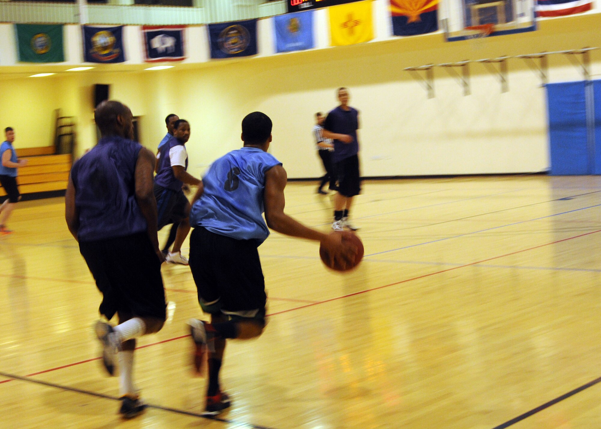 Airman 1st Class Bryson Gardener, 325nd Special Operations Support Squadron cyber operations technician from Rancho Cucamonga, Calif., dribbles down the court during an intramural basketball game Jan. 30, 2013, at the Hardstand Fitness Center at RAF Mildenhall, England. The 352nd SOSS played against the 100th Logistics Readiness Squadron and lost 62-60 in overtime. (U.S. Air Force photo by Airman 1st Class Kelsey Waters/Released)