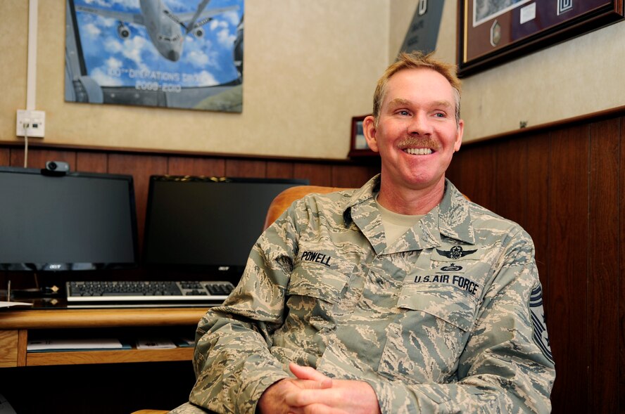 Chief Master Sgt. Christopher Powell, 100th Air Refueling Wing command chief, sets aside his service uniform Feb. 1, 2013, after donning it for three decades. Powell arrived at RAF Mildenhall in July 2008 as the 100th Operations Group superintendent, before becoming the 100th ARW command chief in June 2010. Once retired, Powell plans to rejoin the flying world by earning a helicopter license and pursue hobbies that have been on the back burner until now, such as play the guitar, and take a trip to Mt. Everest's base camp in Nepal. (U.S. Air Force photo by Airman 1st Class Dillon Johnston/Released)