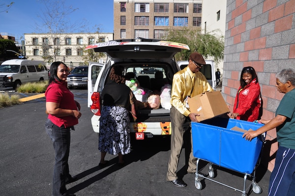 The U.S. Army Corps of Engineers Los Angeles District Black Employment Program honored Martin Luther King Jr. Day with a day of service by delivering more than 100 pounds of collected toiletries and toys to local shelters in the downtown Los Angeles community. Lashawn Richardson, Debra McCree, Matthews Turner and Arnecia Williams, offload donated items at the Downtown Women's Center. (USACE photo by Brooks O. Hubbard)