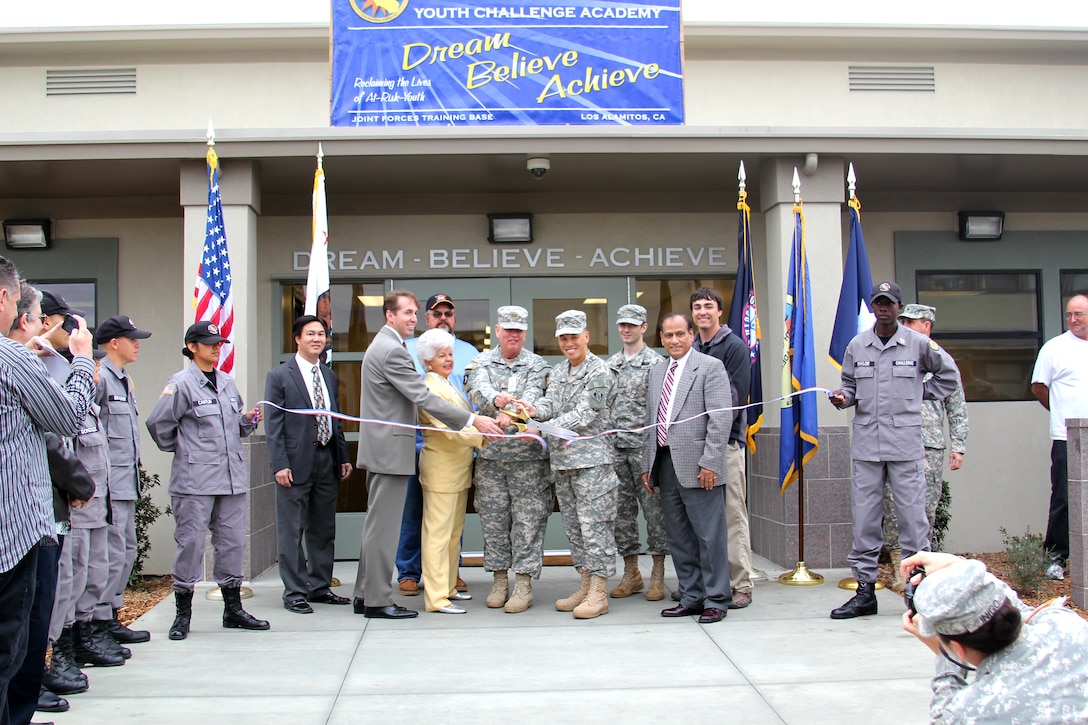 Officials (with scissors), including Los Alamitos Mayor Troy Edgar, Rep. Grace Napolitano, Corps Project Engineer Maj. Phillip Oster and Los Angeles District Commander Col. Mark Toy, cut the ribbon officially opening the Sunburst Youth Academy facilities at Los Alamitos March 16, 2012 as Corps Resident Engineer Mike Siu, Corps Quality Assurance Representative Jim Miller, Executive Officer Maj. Kenneth Shubert, Corps Project Manager Shawn Basu and Corps Project Engineer Greg Ripperger look on.