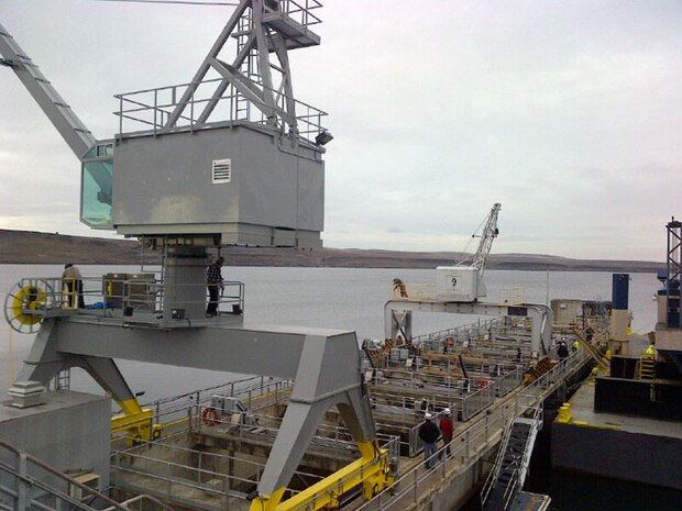 Workers install a newly built 10-ton portal crane at McNary Lock and Dam near Umatilla, Ore., Jan. 29.