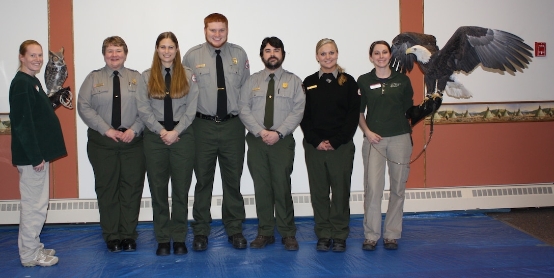 Corps staff pose with some special friends during Gavins Point's annual Bald Eagle Day Program.  From left, Laura Freeman holding a great-horned owl, Karla Zeutenhorst, Linda Filo, Jeff Cook, Justin Work (NPS), Katie Burgi, and Katie Burnes holding a bald eagle.  