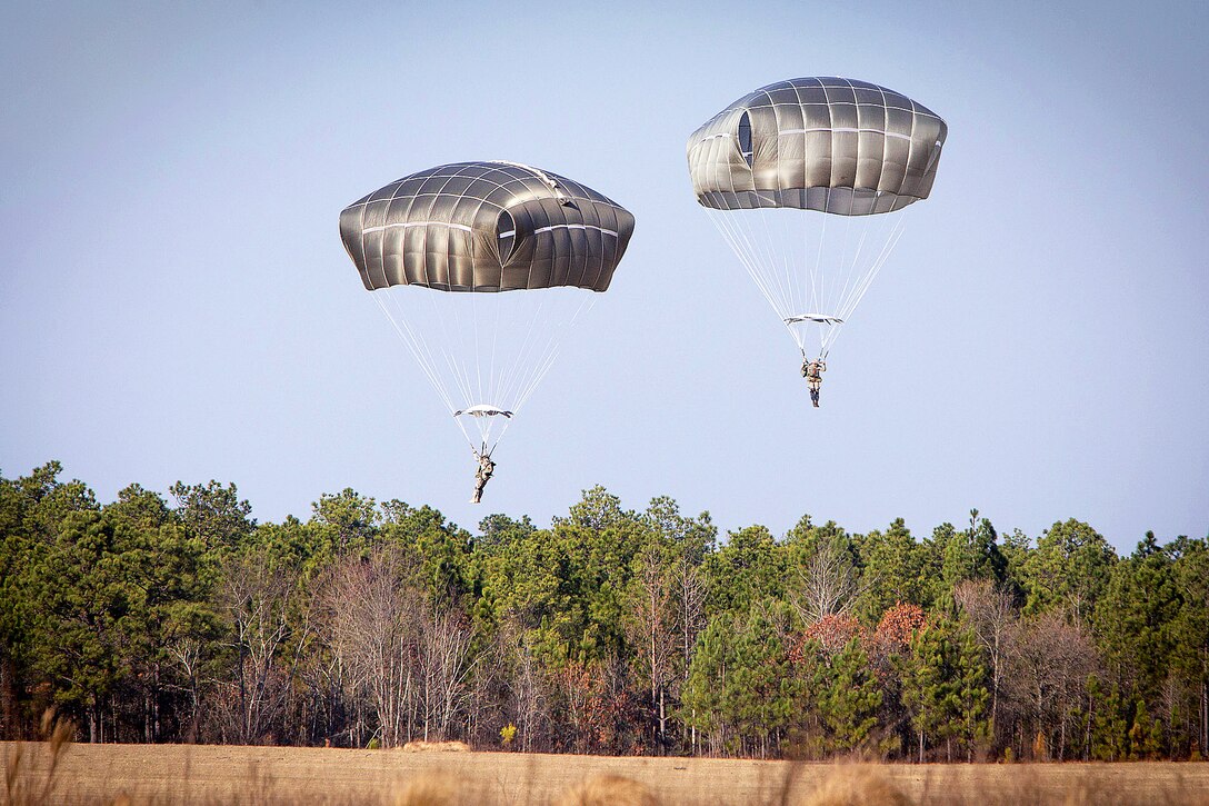 Paratroopers using the Army’s new T-11 parachute system descend onto a drop zone during an airborne training operation on Fort Bragg, N.C., Jan. 29, 2013.