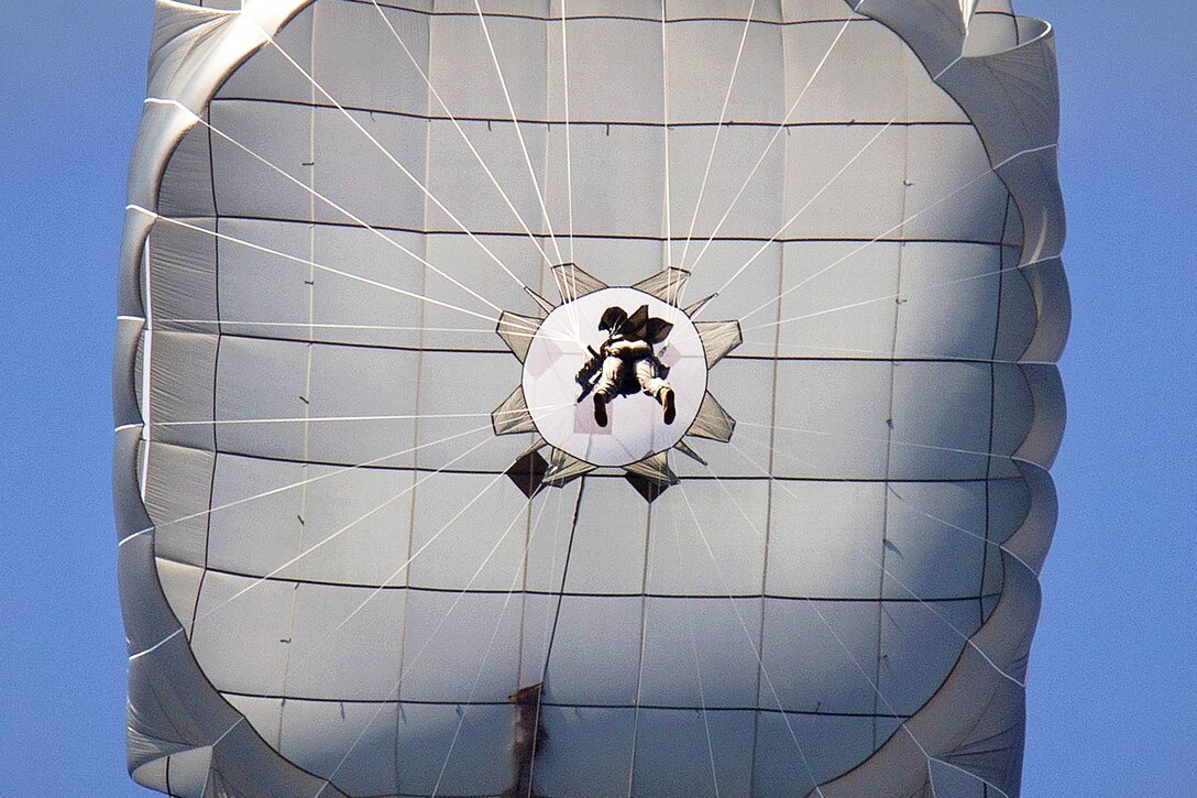 A paratrooper descends to a drop zone using the Army’s new T-11 parachute system on Fort Bragg, N.C., Jan. 29, 2013. The paratrooper is assigned to the 82nd Airborne Division’s 1st Brigade Combat Team. The square canopy has nearly a third more surface area than that of the T-10D parachute that it replaces.