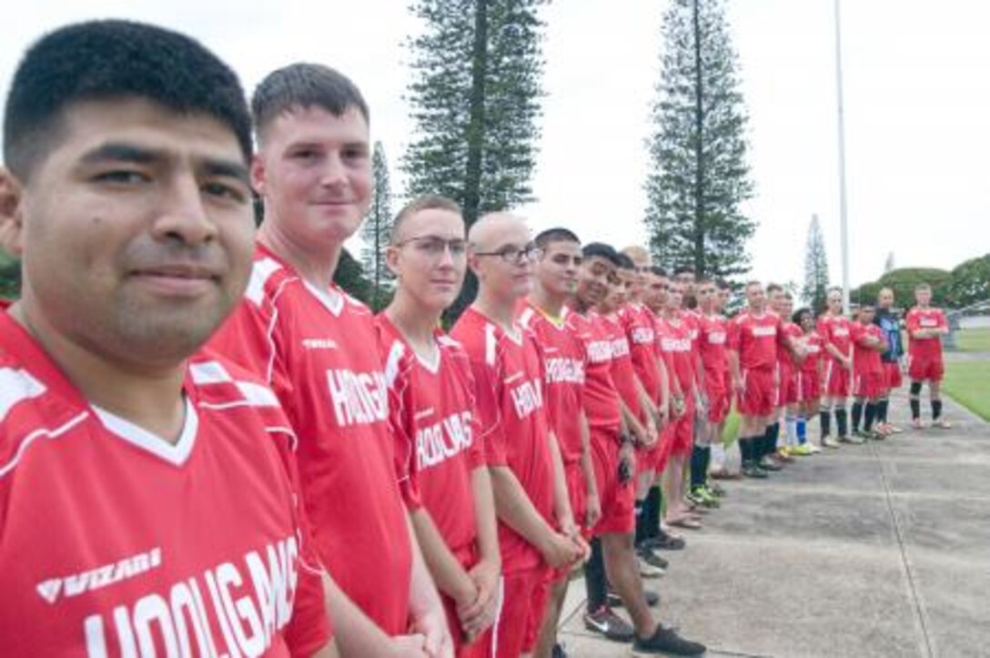 More than 20 members of 3rd Marine Regiment’s soccer team, the “Hooligans,” stand together in their new uniforms earlier this month. This season is the Hooligans’ first intramural soccer season playing together.
