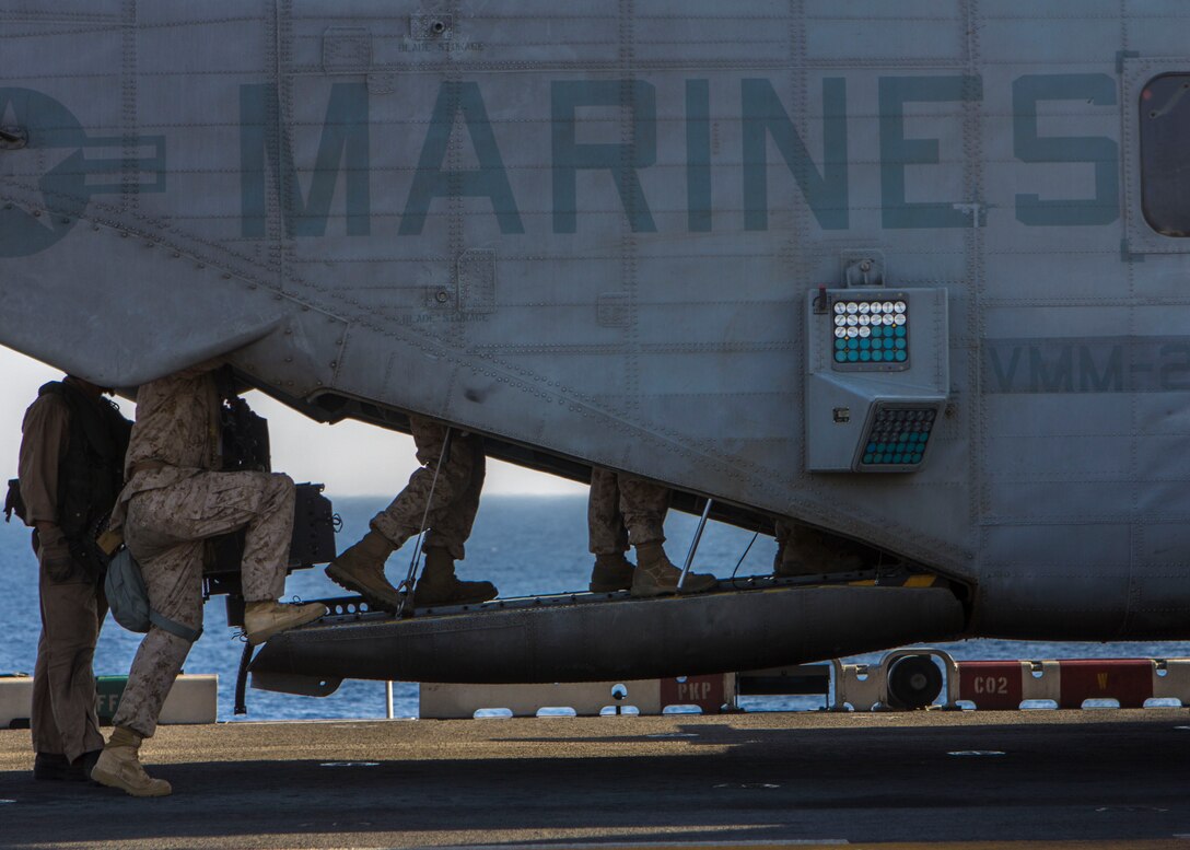 U.S. Marines assigned to Battalion Landing Team 3/2, 26th Marine Expeditionary Unit (MEU), board a CH-53E Super Stallion assigned to Marine Medium Tiltrotor Squadron (VMM) 266 (Reinforced), 26th MEU, to conduct fast rope familiarization training on the flight deck of the USS Kearsarge (LHD 3), at sea, June 30, 2013. The 26th MEU is a Marine Air-Ground Task Force forward-deployed to the U.S. 5th Fleet area of responsibility aboard the Kearsarge Amphibious Ready Group serving as a sea-based, expeditionary crisis response force capable of conducting amphibious operations across the full range of military operations. (U.S. Marine Corps photograph by Sgt. Christopher Q. Stone, 26th MEU Combat Camera/Released)