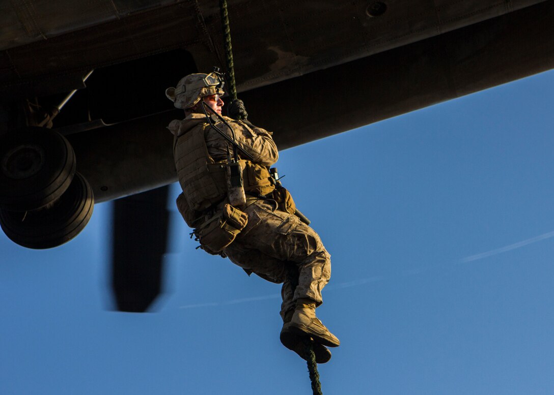 A U.S. Marine assigned to Battalion Landing Team 3/2, 26th Marine Expeditionary Unit (MEU), fast ropes from a CH-53 Super Stallion assigned to Marine Medium Tiltrotor Squadron (VMM) 266 (Reinforced), 26th MEU, during familiarization training on the flight deck of the USS Kearsarge (LHD 3), at sea, June 30, 2013. The 26th MEU is a Marine Air-Ground Task Force forward-deployed to the U.S. 5th Fleet area of responsibility aboard the Kearsarge Amphibious Ready Group serving as a sea-based, expeditionary crisis response force capable of conducting amphibious operations across the full range of military operations. (U.S. Marine Corps photograph by Sgt. Christopher Q. Stone, 26th MEU Combat Camera/Released)