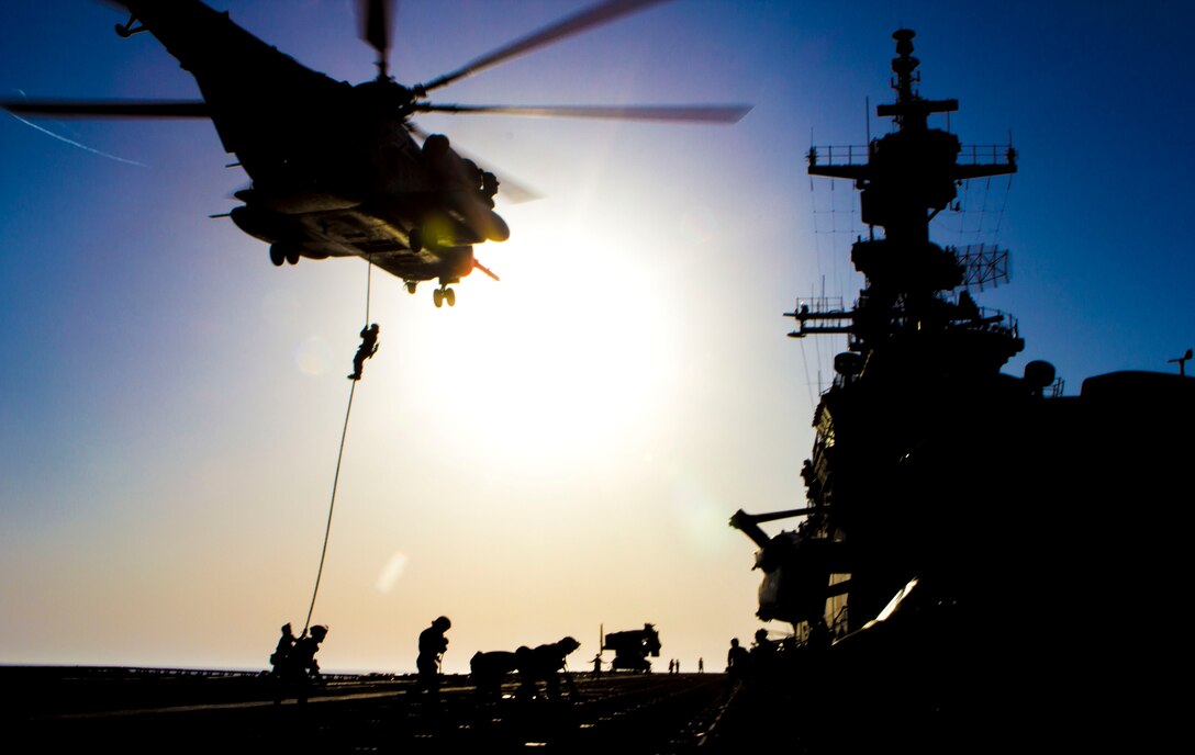 A U.S. Marine assigned to Battalion Landing Team 3/2, 26th Marine Expeditionary Unit (MEU), fast ropes from a CH-53 Super Stallion assigned to Marine Medium Tiltrotor Squadron (VMM) 266 (Reinforced), 26th MEU, during familiarization training on the flight deck of the USS Kearsarge (LHD 3), at sea, June 30, 2013. The 26th MEU is a Marine Air-Ground Task Force forward-deployed to the U.S. 5th Fleet area of responsibility aboard the Kearsarge Amphibious Ready Group serving as a sea-based, expeditionary crisis response force capable of conducting amphibious operations across the full range of military operations. (U.S. Marine Corps photograph by Sgt. Christopher Q. Stone, 26th MEU Combat Camera/Released)
