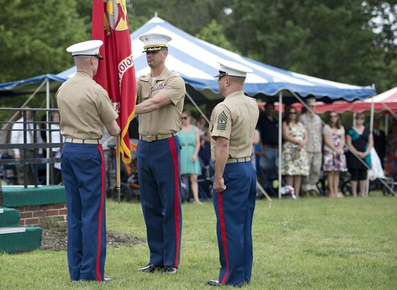 Lt. Col. Ryan R. Gutzwiller passes the Marine Corps flag to Lt. Col. Steven Riffer to symbolize the relinquishing of command, form Gutzwiller to Riffer. Photo by Pfc. Dylan M. Bowyer.