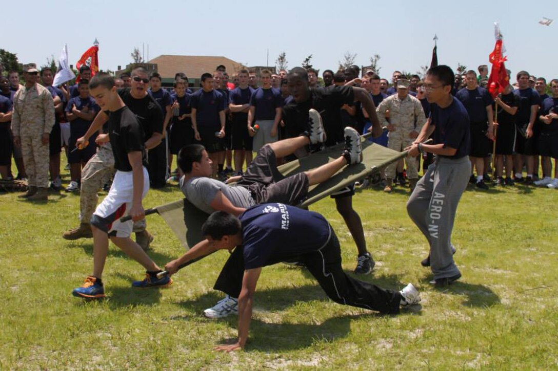Poolees, young men and women in the Delayed Entry Program waiting to ship to recruit training, compete in a stretcher relay at the annual Sergeant Major's Cup field meet at Jones Beach in Wantagh, N.Y., June 15. The field meet is aimed toward building physical fitness, teamwork and camaraderie.