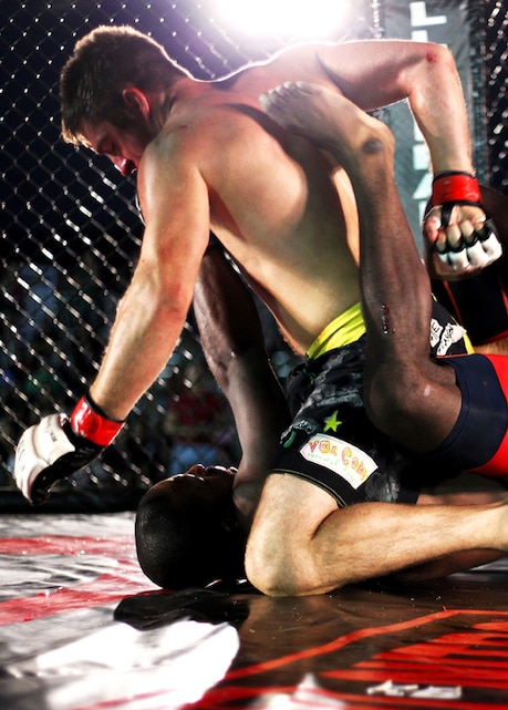 Ryan Dean pins his opponent, Geoff Ross, during Summer Fight Night IV held at the Combat Center’s Del Valle Field June 21, 2013. 