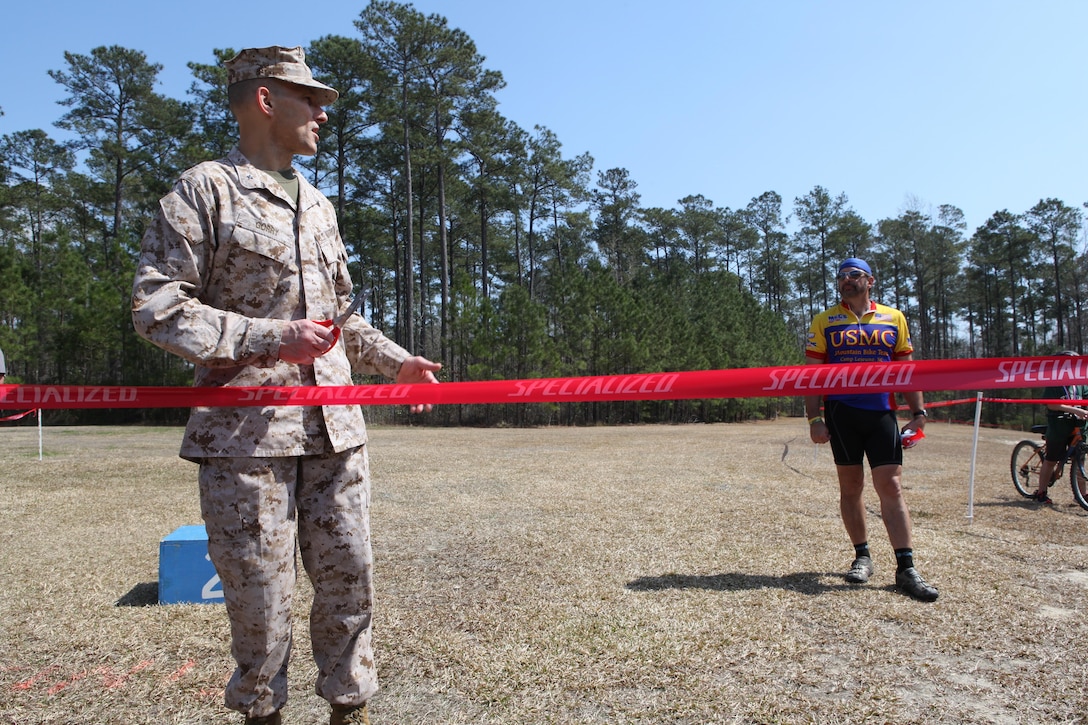 Brig. Gen. Thomas A. Gorry, the commanding general of Marine Corps Installations East – Marine Corps Base Camp Lejeune, thanks LeBlanc for creating something families can enjoy through a new bike trail before cutting the ribbon, marking its opening at Henderson Pond Recreation Area aboard Marine Corps Base Camp Lejeune March 17. It was the first race held by Down East Cyclists, a local cycling club, in three years. (Photo by Pfc. Justin A. Rodriguez/released)