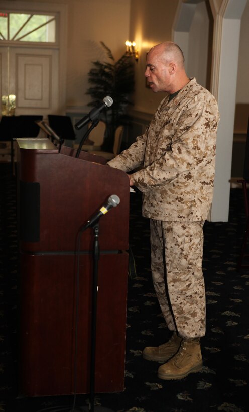 Cmdr. Jon W. Lyle, a Catholic chaplain, leads a prayer for the nation and leaders during the National Day of Prayer breakfast at the Paradise Point Officer’s Club aboard Marine Corps Base Camp Lejeune May 2. Six Chaplains led more than 100 attendees from different beliefs and denominations. (Photo by Pfc. Justin A. Rodriguez/released)