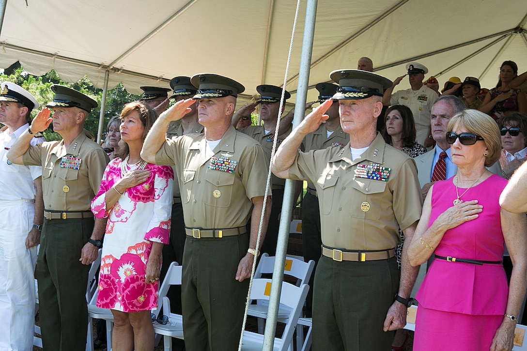 NORFOLK (June 28, 2013) - Commandant of the Marine Corps Gen. James F. Amos, Lynn Crowe, Brig. Gen. W. Blake Crowe, Lt. Gen. Richard T. Tryon, and Diane Tryon salute during the passing of the colors during the change of command for U.S. Marine Forces Command aboard Naval Support Activity Hampton Roads, June 28th, 2013.