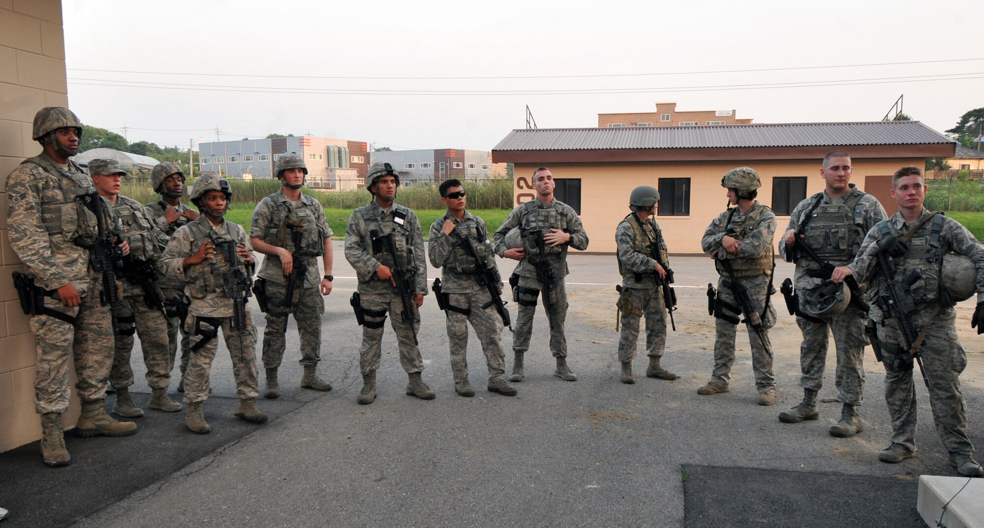 Quick Reaction Team members from the 51st Security Forces Squadron discuss their performance from the joint QRT training exercise at Osan Air Base, Republic of Korea, June 29, 2013. Security forces trained with other emergency responders during this specific exercise. These exercises and training opportunities facilitate the learning of specialized skills, pooling of resources, and effective development of tactics, techniques, and procedures based on how these emergency responders will deploy during mass casualty incidents, terrorist attacks, and other high risk responses.  (U.S. Air Force photo/Senior Airman Alexis Siekert)