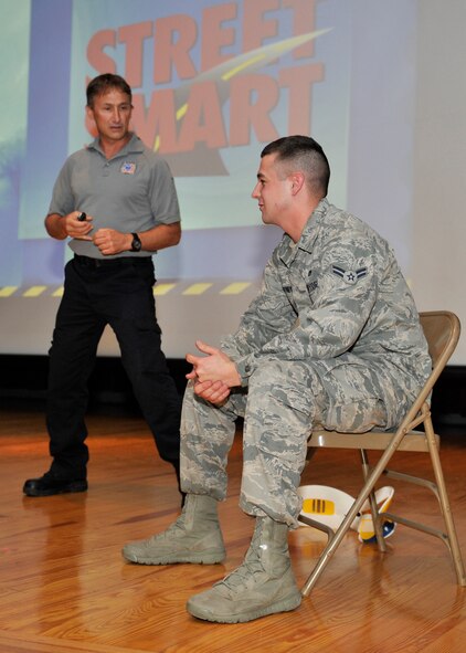 Vince Easevoli, Stay Alive From Education founder, speaks to Airman 1st Class Scott Pitney, 92nd Logistics Readiness Squadron fire truck maintenance apprentice, at Fairchild Air Force Base, Wash. June 20, 2013. Pitney volunteered to be taken through a simulated trauma situation to demonstrate the danger people face by making poor decisions on the road. (U.S. Air Force photo by Staff Sgt. Michael Means/Released)