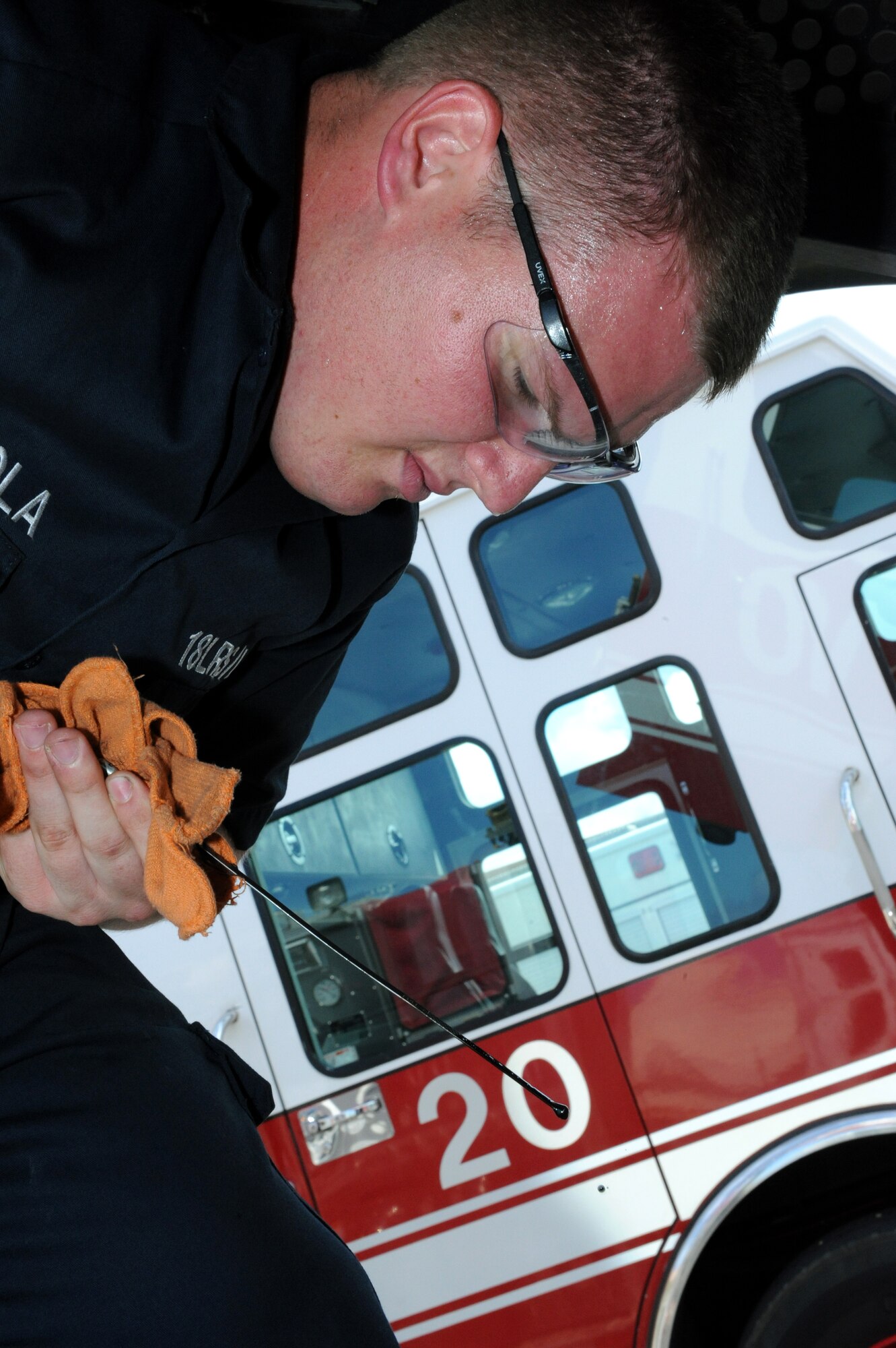 U.S. Air Force Senior Airman Nicholas Lamendola, 18th Logistics Readiness Squadron fire truck maintenance technician, checks the oil of a fire truck on Kadena Air Base, Japan, July 1, 2013. 18th LRS fire truck technicians ensure the trucks are ready to mitigate in-flight emergencies and enable the 18th Civil Engineer Squadron Fire and Emergency Services flight to respond to residential and work place emergencies. (U.S. Air Force photo by Airman 1st Class Hailey R. Davis/Released)