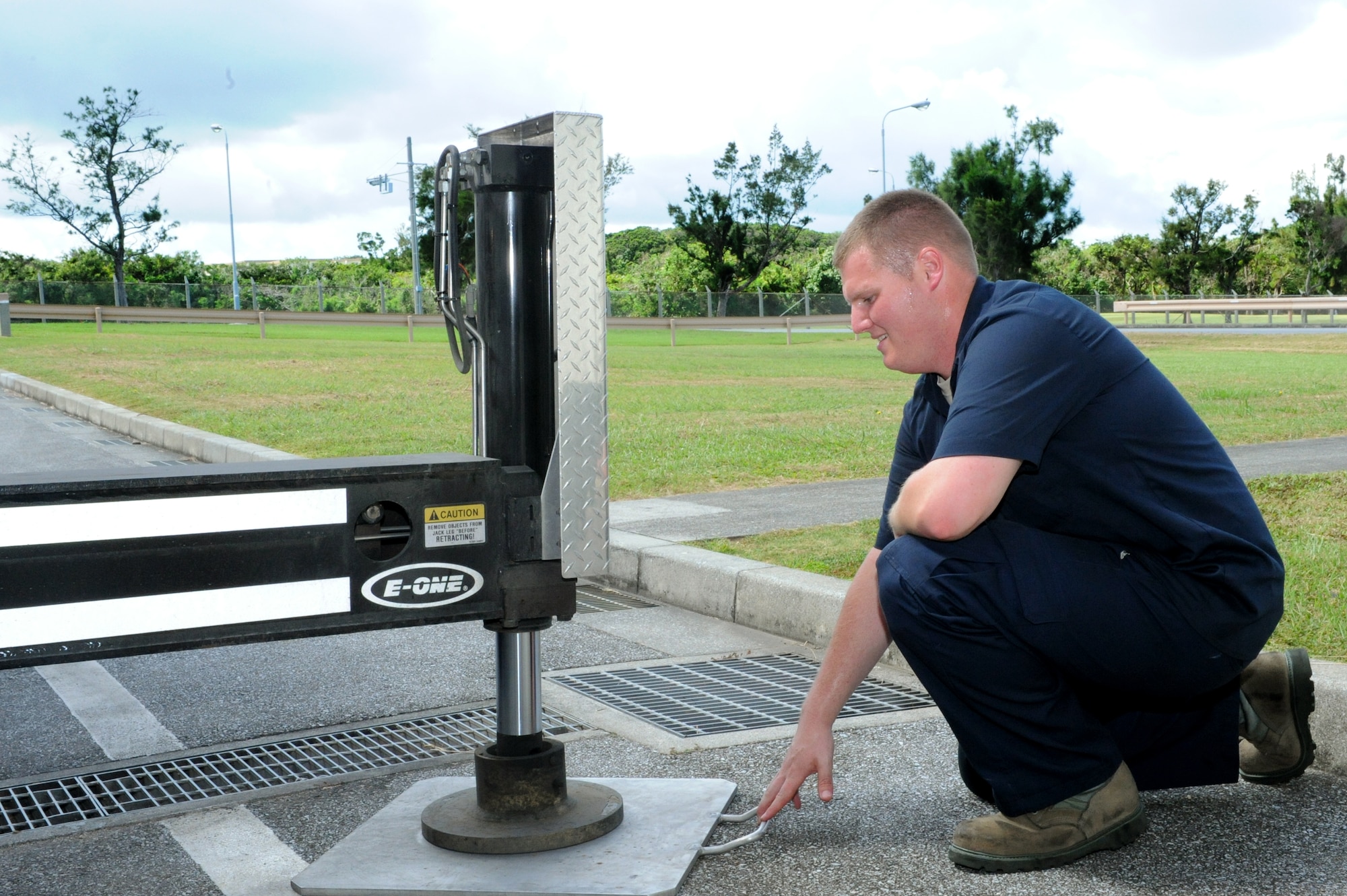 U.S. Air Force Senior Airman Nicholas Lamendola, 18th Logistics Readiness Squadron fire truck maintenance technician, places a stabilizing plate beneath a hydraulic jack on Kadena Air Base, Japan, July 1, 2013. 18th LRS fire truck technicians provide maintenance on the wing's aircraft crash and rescue trucks, structural fire trucks and fire suppression equipment. (U.S. Air Force photo by Airman 1st Class Hailey R. Davis/Released)