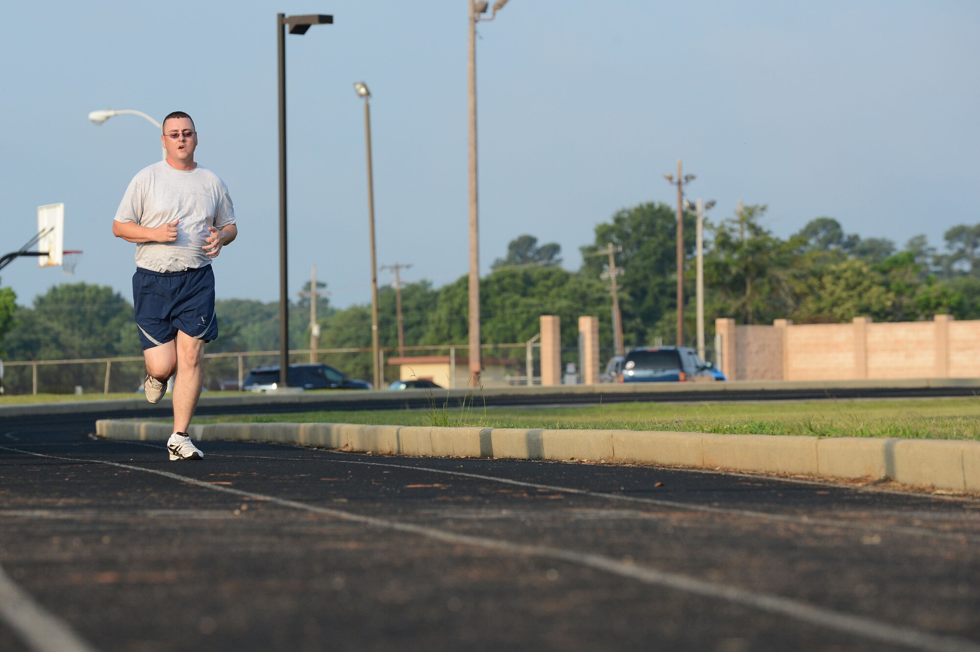 U.S. Air Force Staff Sgt. Jonathan McBride, 20th Logistics Readiness Squadron NCO in charge of physical inventory, runs on the track at Shaw Air Force Base, S.C., June 28, 2013.  In the Air Force, it is required for Airmen to maintain physical fitness standards, which they are also tested on.  As of July 1, if Airmen at Shaw do not meet the minimum standard, they will be offered classes such as Running 101 and Healthy Weight 101. (U.S. Air Force photo by Airman 1st Class Nicole Sikorski/Released).