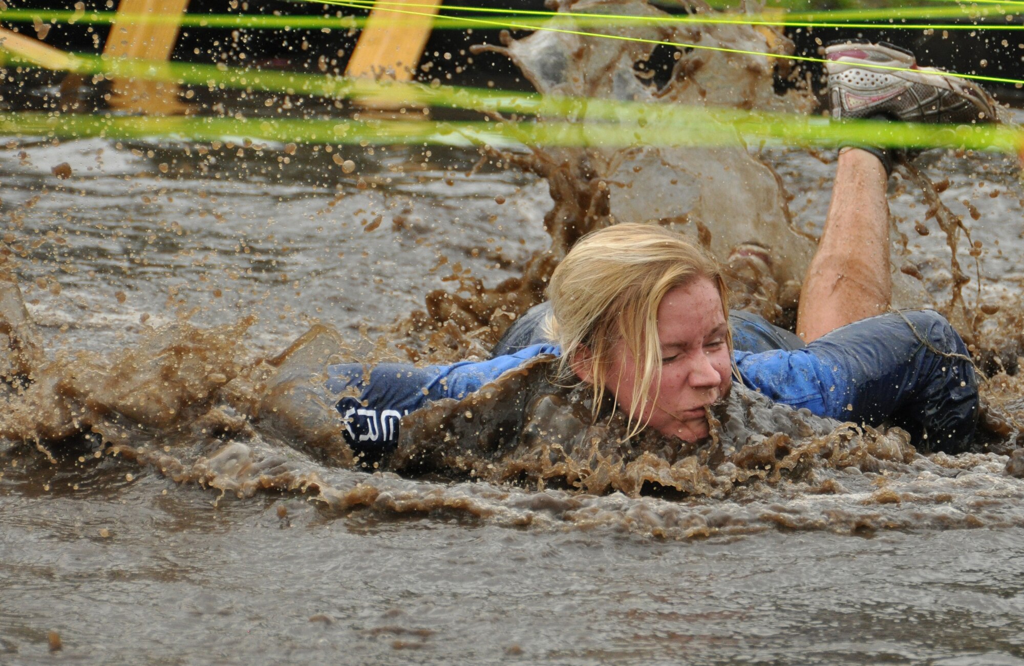 Helen Dickinson, 477th Force Support Squadron, makes her way through the final water obstacle during the Anchorage Community Mental Health Services Race for Recovery June 29. Reserve members from the 477th Fighter Group took part in the second annual event known as the “Mud Run.” The 5-kilometer course featured mud and water pits as well as swampy terrain and climbing walls for each runner to navigate over or through. The event rose over $50,000 for Anchorage Community Mental Health Services. (U.S. Air Force photo/Tech. Sgt. Dana Rosso)